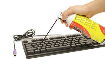 cleaning the keyboard with compressed air